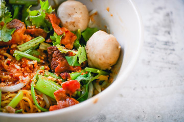 Asian noodles with vegetables on the cement table. Top view with copy area.