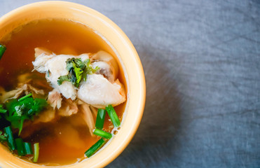Chicken rice soup on a stainless steel table. Top view with copy area.