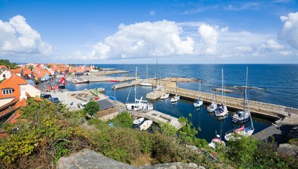 View of fishing boats and yachts moored in the harbor in Gudhjem, Bornholm island, Denmark - obrazy, fototapety, plakaty