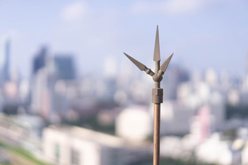 Lightning rod on the top of a tall building in a large city for safety - obrazy, fototapety, plakaty