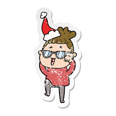 distressed sticker cartoon of a happy woman wearing spectacles wearing santa hat
