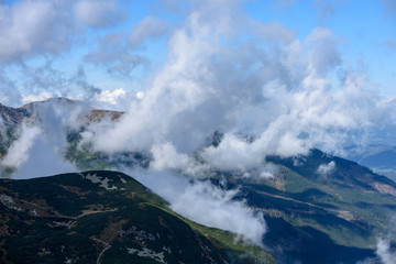 Tatra mountain peaks with tourist hiking trails in sunny summer day