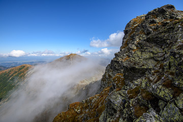 Tatra mountain peaks with tourist hiking trails in sunny summer day