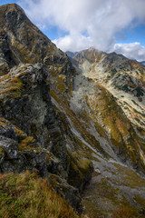 Tatra mountain peaks with tourist hiking trails in sunny summer day