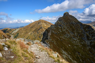 Fototapeta na wymiar Tatra mountain peaks with tourist hiking trails in sunny summer day