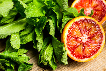Sweet juicy red oranges on the rustic background. Selective focus. Shallow depth of field. 
