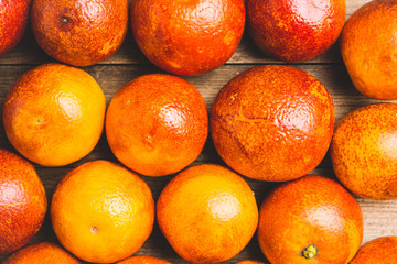 Sweet juicy red oranges on the rustic background. Selective focus. Shallow depth of field. 