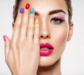 Beautiful fashion woman with a colored nails. Attractive white girl with multicolor manicure.