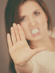 Angry apodicticity woman showing stop with hand