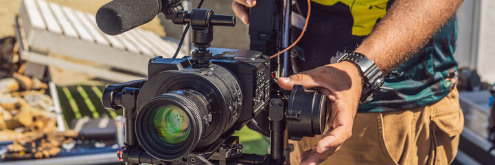 Steadicam operator prepare camera and 3-axis stabilizer-gimbal for a commercial shoot BANNER, LONG...