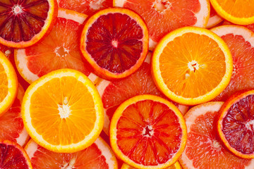 Different kinds of oranges and grapefruit slices background