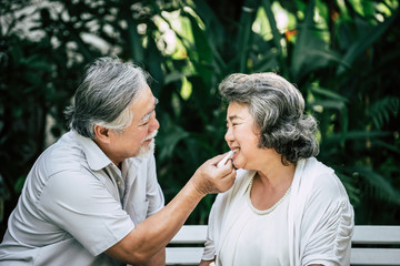 Elderly Couples Playing and eating some fruit