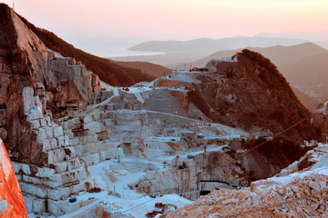 Carrara marble quarry, extraction and processing of white marble, sunset