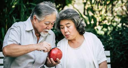 Fototapeta na wymiar Elderly Couples Playing and eating some fruit