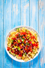 Pasta with vegetables on wooden background