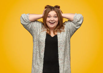 Excited overweight female rumpling hair