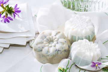 Handmade soaps on the white material, cleanliness and hygiene concept