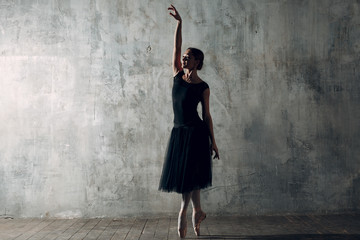 Ballerina female. Young beautiful woman ballet dancer, dressed in professional outfit, pointe shoes...