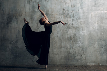 Ballerina female. Young beautiful woman ballet dancer, dressed in professional outfit, pointe shoes and black tutu.