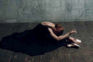 Ballerina female. Young beautiful woman ballet dancer, dressed in professional outfit, pointe shoes and black tutu.