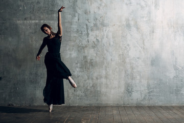 Ballerina female. Young beautiful woman ballet dancer, dressed in professional outfit, pointe shoes and black tutu.