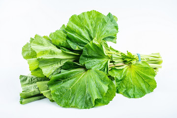 Fototapeta premium A handful of fresh green winter leeks on a white background