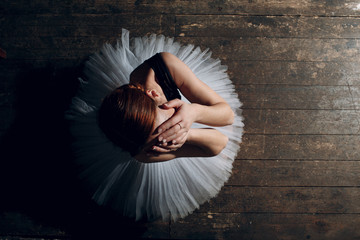 Ballerina female. Young beautiful woman ballet dancer, dressed in professional outfit, pointe shoes and white tutu.