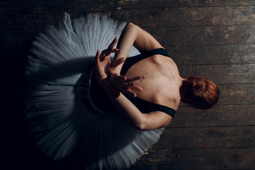 Ballerina female. Young beautiful woman ballet dancer, dressed in professional outfit, pointe shoes and white tutu.
