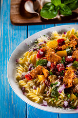 Pasta with vegetables on wooden background