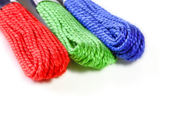 Three sawing silk threads in colors rgb with white copy space for text.
