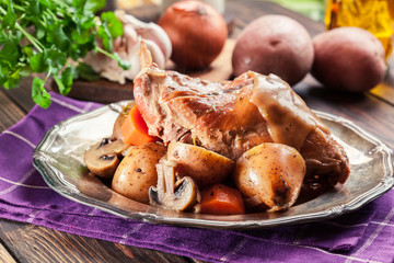 Stewed rabbit legs with vegetables