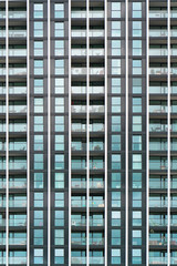 Obraz premium Glass blue square Windows of facade modern city business building skyscraper. Modern apartment buildings in new neighborhood. Windows of a building, texture.