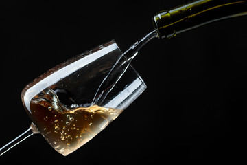 White wine being poured into wine glass.