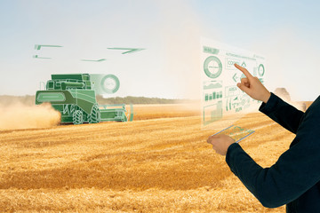 Farmer controls autonomous harvester. 