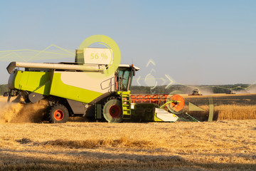 A modern combine harvester harvests wheat using a head-up display and the Internet of things in...