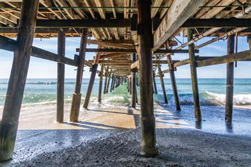 Coastal View from Under a Wooden Pier