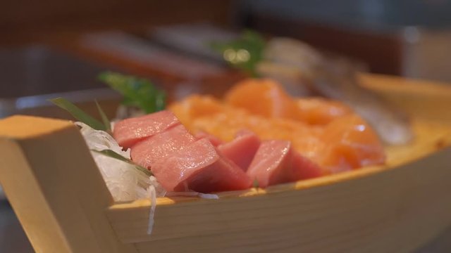 Japanese chef use sharp knife slicing fresh fish for sashimi.  Squid, Salmon, Hotate