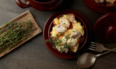  Meat stewed with potatoes, carrots and spices on wooden background.