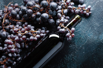 Bottle of red wine and grapes.