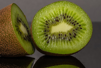 Fototapeta na wymiar Kiwi. Reflectiv. Fruit. Slice. Black. Juicy