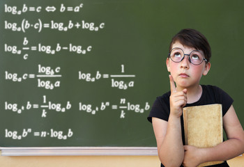 Little girl and green blackboard. Wunderkind