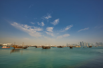 Skyline of Doha with traditional arabic dhows. Qatar, Middle East