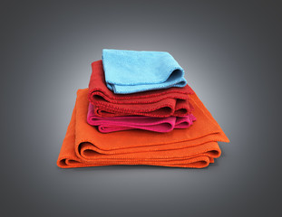 Pile of colored towels isolated on black gradient background 3d