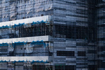 Numerous scaffolds are assembled in the building under construction.