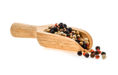 dried peppers in wood scoop isolated on white background
