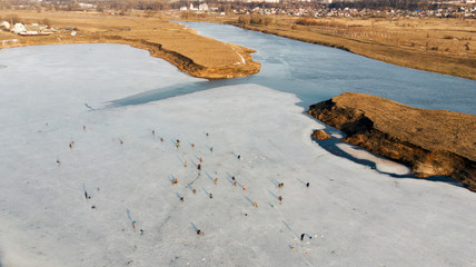 Aerial view of winter fishing.Dangerous fishing on the last ice.