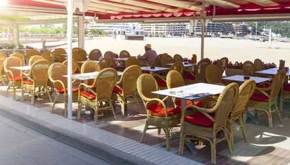 The Table and chairs in empty cafe near the beach