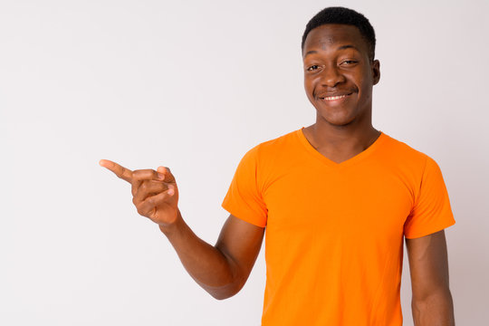 Portrait Of Young Happy African Man Pointing To The Side