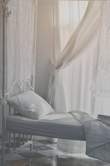 The white bed is in the sun-warmed bedroom in the morning. White bedroom in the morning.Do not focus on objects.