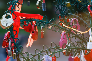 red love locks hang on the newlyweds tree, a symbol of love and loyalty at the Tretyakov Bridge in Moscow, Russia